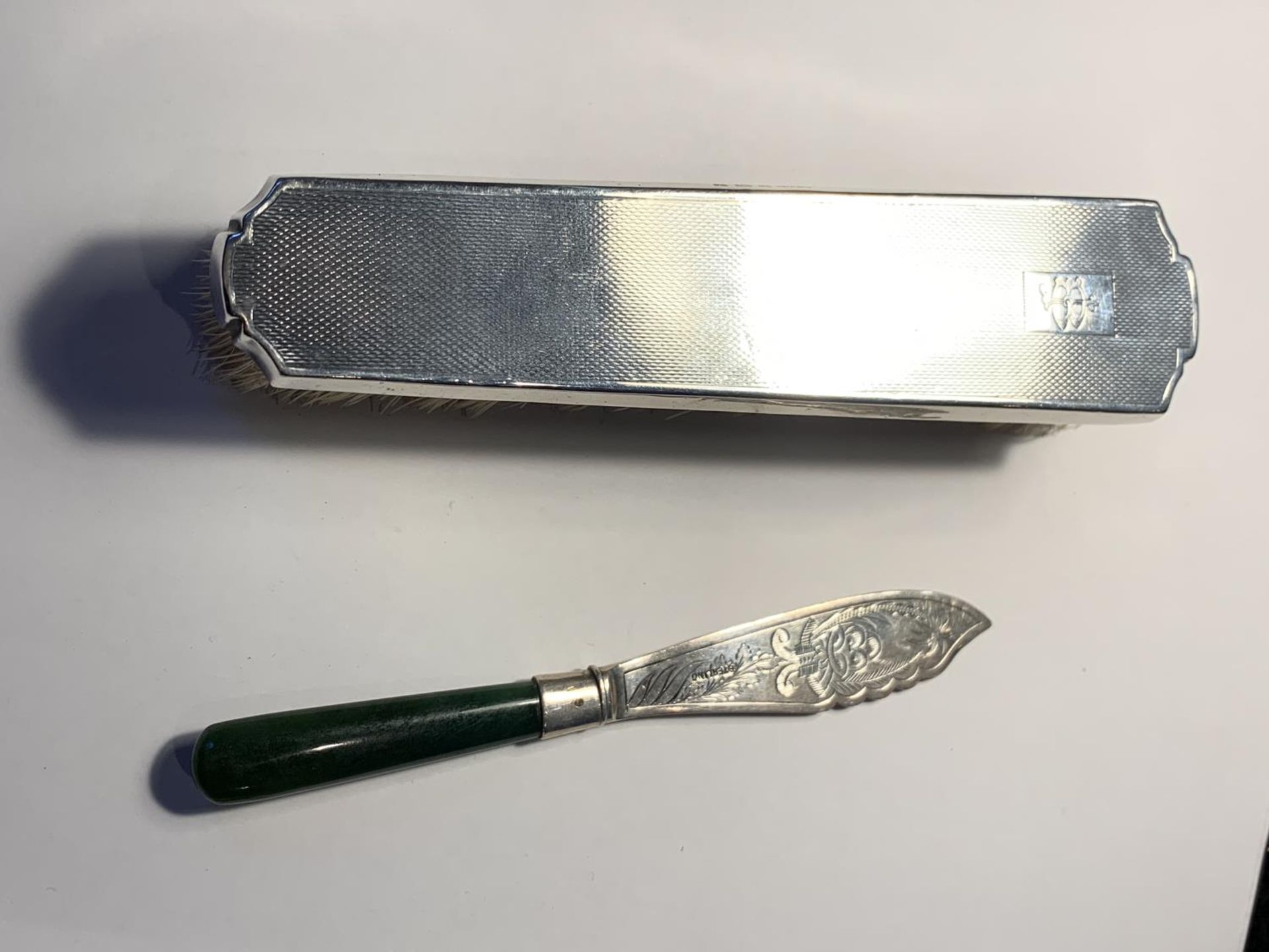 A HALLMARKED BIRMINGHAM SILVER BRUSH AND A MARKED STERLING BUTTER KNIFE