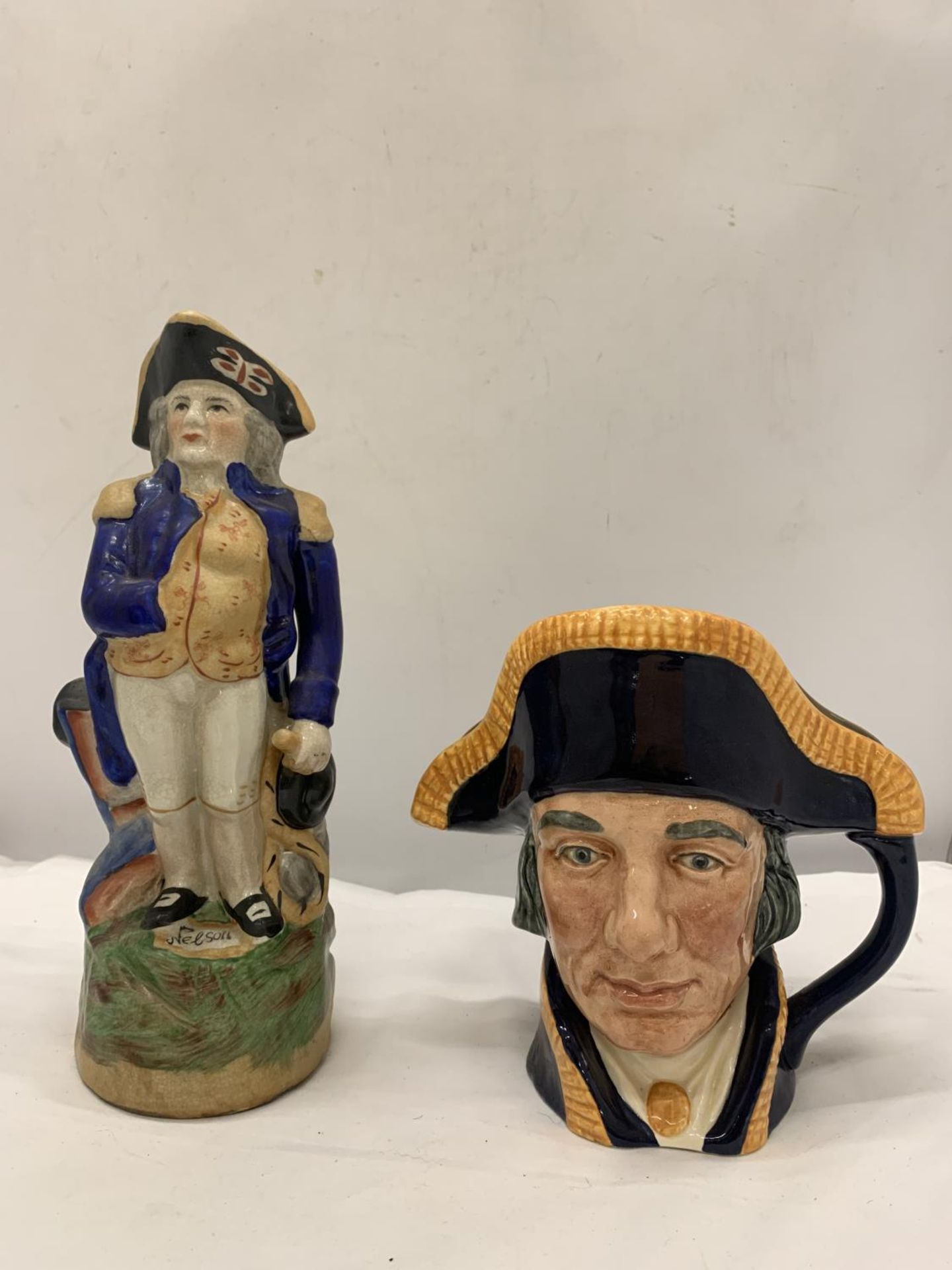A VINTAGE STAFFORDSHIRE LORD NELSON JUG AND A ROYAL DOULTON LORD NELSON TOBY JUG