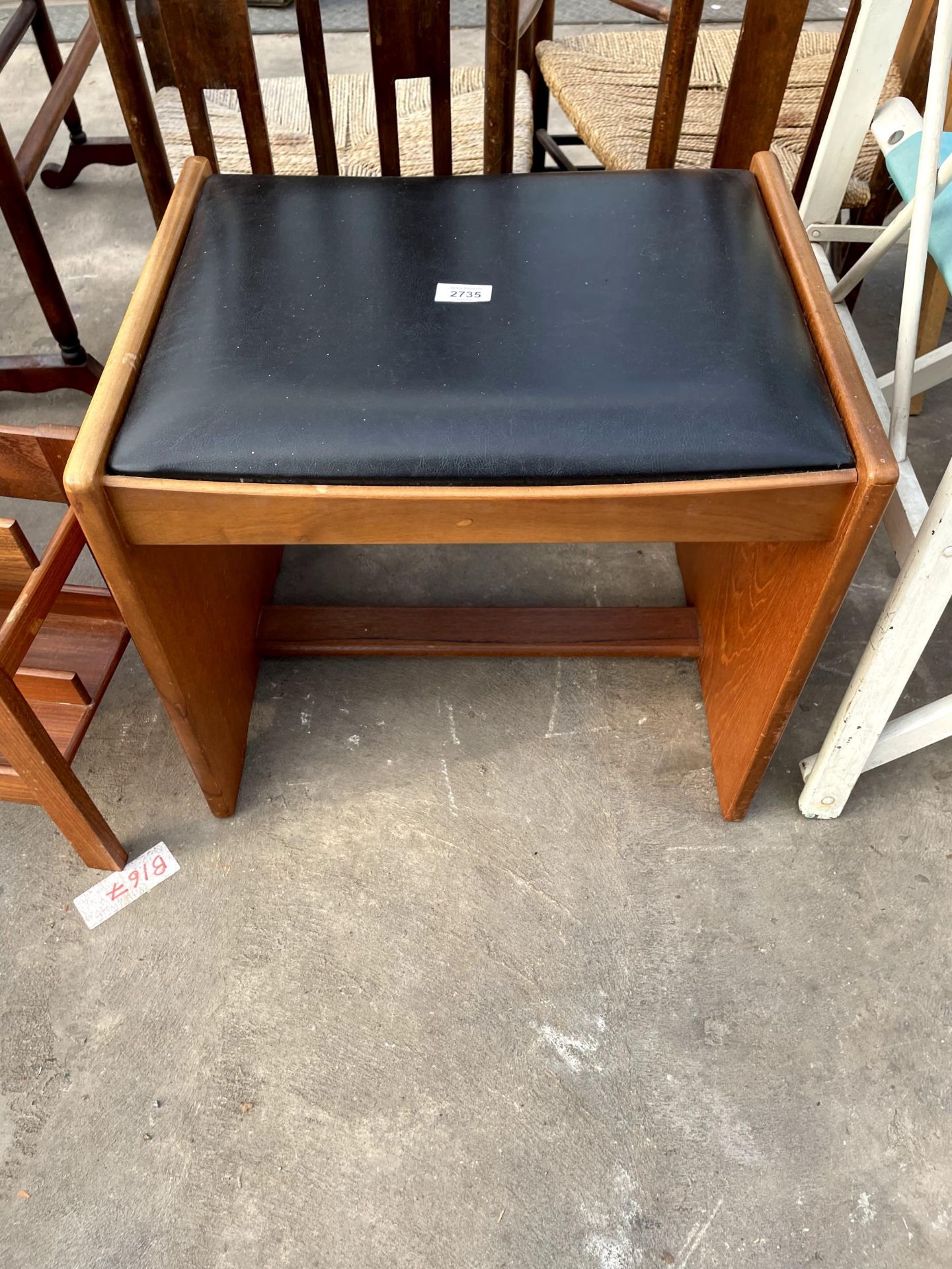 A RETRO TEAK STOOL WITH BLACK FAUX LEATHER SEAT