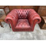 AN OXBLOOD BUTTONED LEATHER ARMCHAIR
