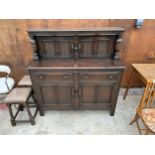 A REPRODUCTION OAK COURT CUPBOARD WITH CARVED PANEL DOORS AND DRAWERS, 51" WIDE