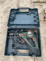 A BOSCH ELECTRIC HAMMER DRILL WITH CARRY CASE