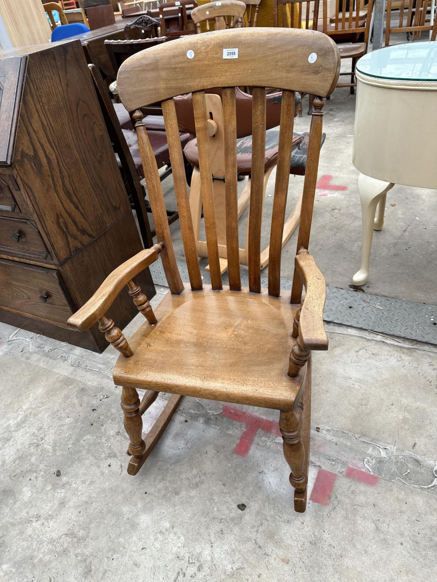 A VICTORIAN STYLE ELM AND BEECH LATH BACK ROCKING CHAIR