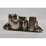 TWO BRASS TANKARDS, A PEWTER TANKARD, STAINLESS STEEL TEA POT, HOT WATER JUG AND CREAM JUG ON A TRAY