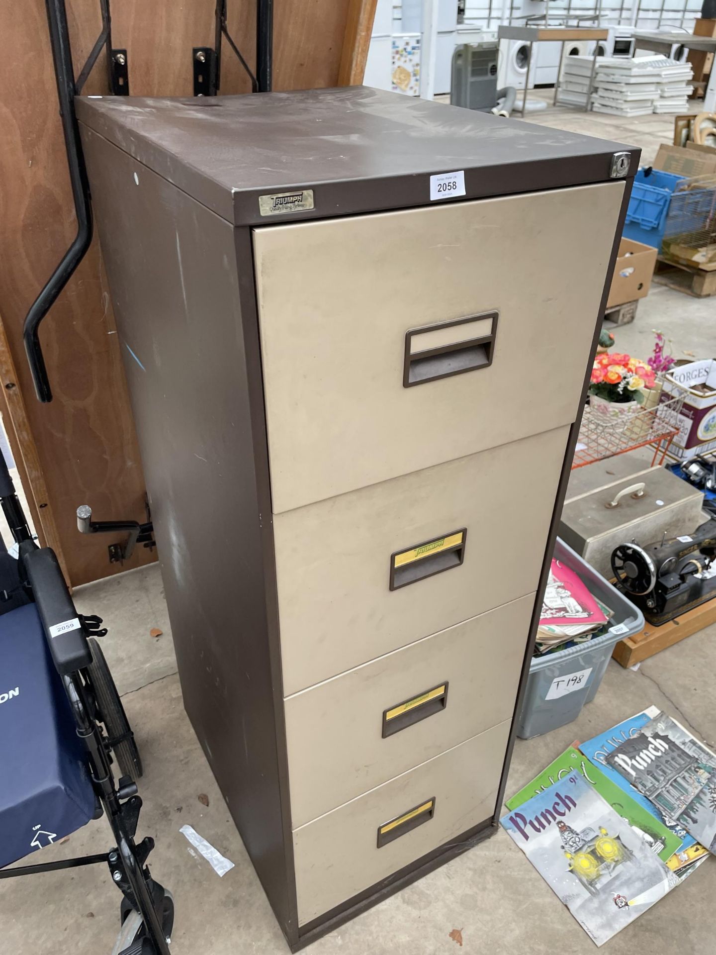 A FOUR DRAWER METAL TRIUMPH FILING CABINET