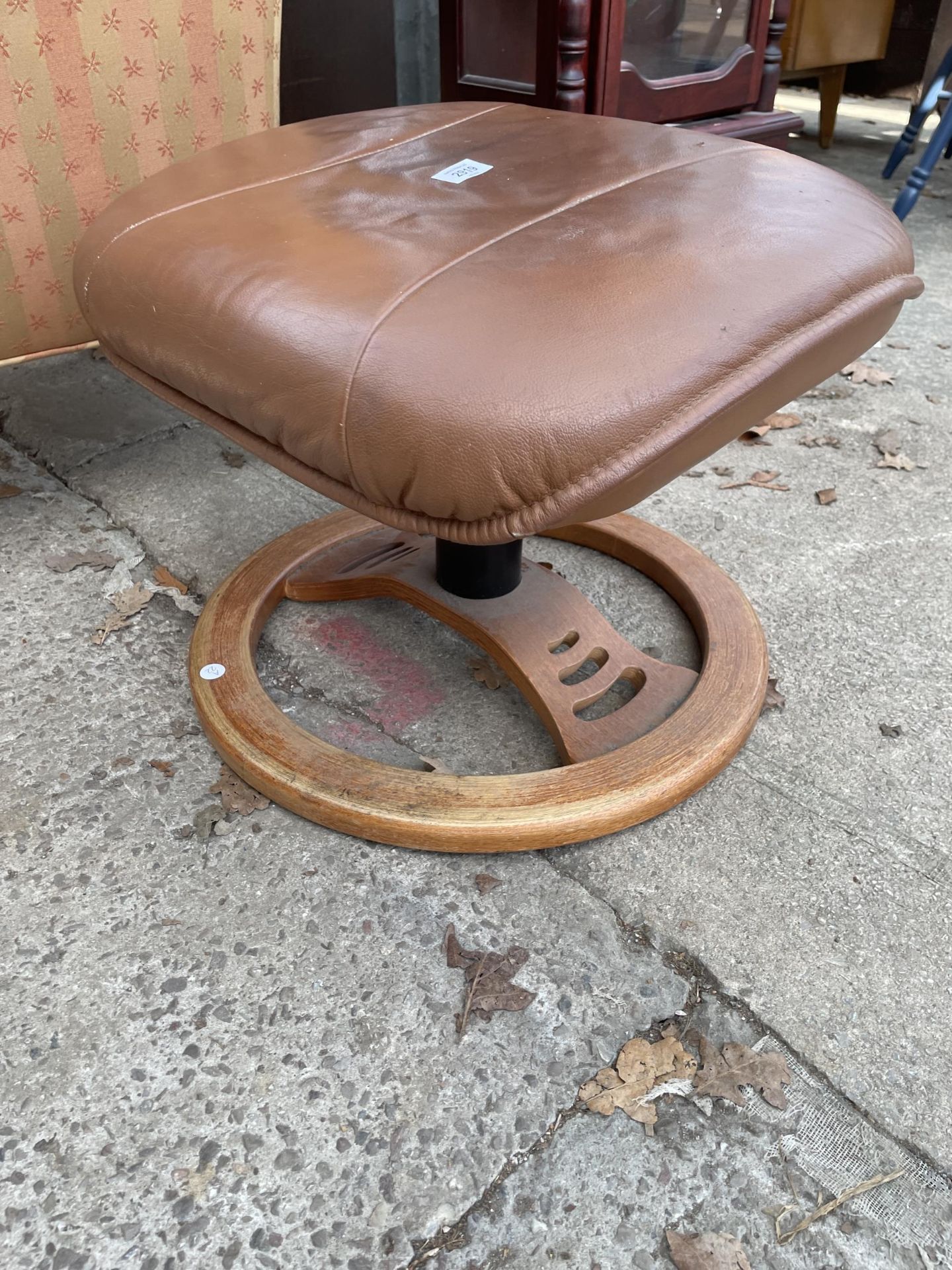 A MODERN BROWN LEATHER FOOTSTOOL