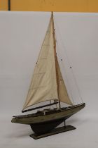 A LARGE WOODEN MODEL OF A SAILING BOAT ON A WOODEN STAND, HEIGHT 104CM, WIDTH 75CM