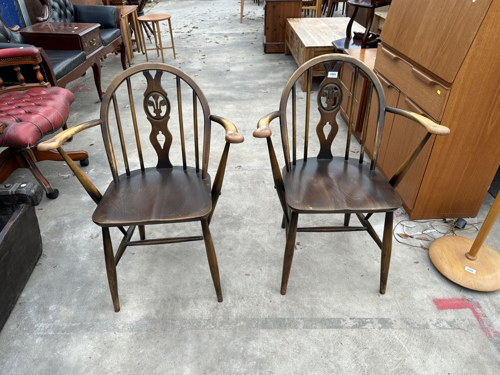 A PAIR OF ERCOL BLUE LABEL PLUME OF FEATHERS CARVER CHAIRS