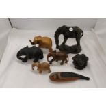 A QUANTITY OF WOODEN CARVED ANIMALS TO INCLUDE ELEPHANTS, A GIRAFFE, ETC