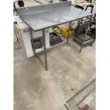 A TALL STAINLESS STEEL INDUSTRIAL KITCHEN WORK BENCH
