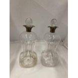 A PAIR OF HALLMARKED BIRMINGHAM SILVER COLLARED GLUG DECANTERS WITH PINCHED AND FLUTED CENTRAL WAIST