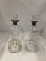 A PAIR OF HALLMARKED BIRMINGHAM SILVER COLLARED GLUG DECANTERS WITH PINCHED AND FLUTED CENTRAL WAIST
