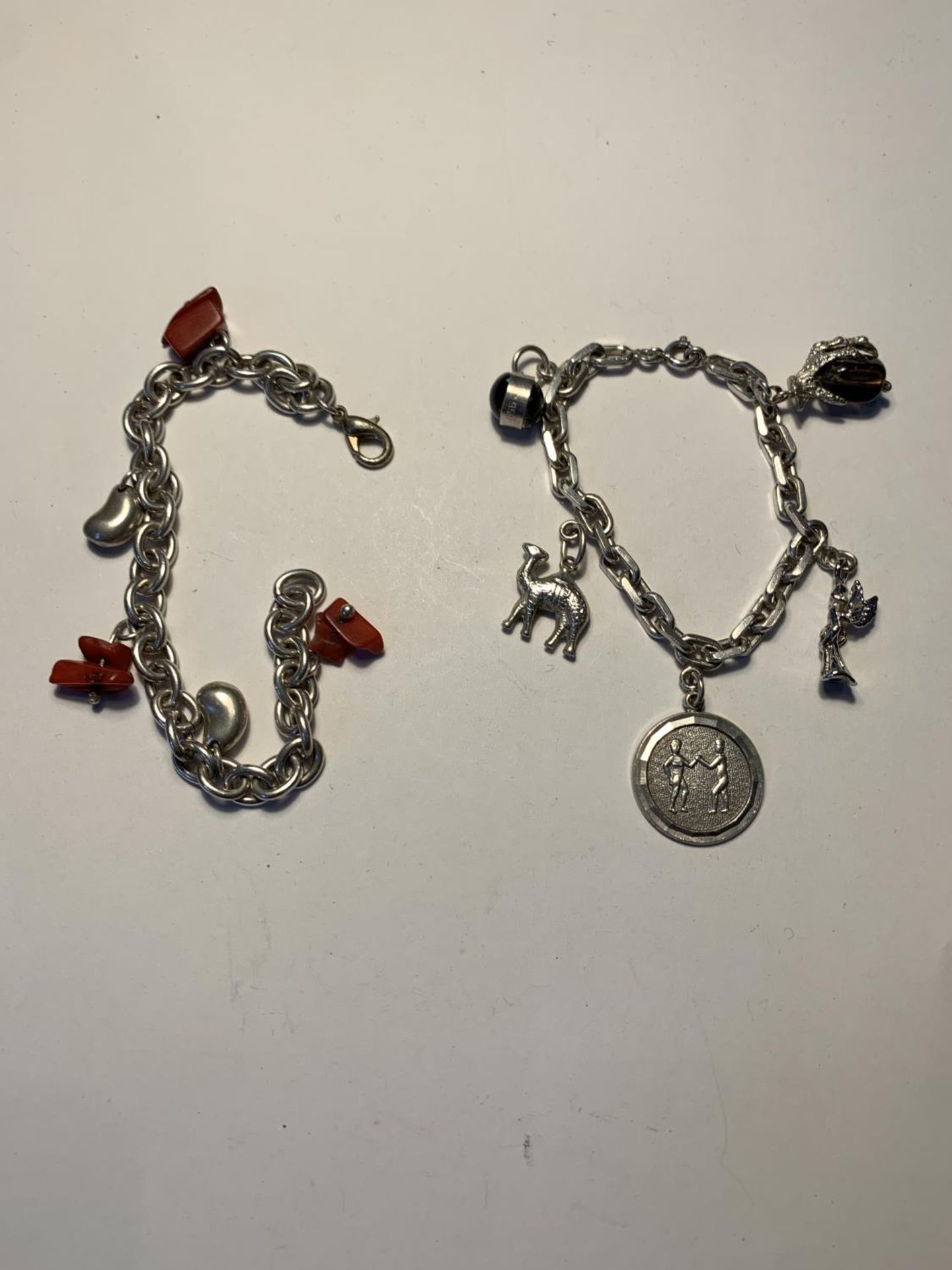TWO SILVER BRACELETS WITH CHARMS