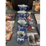 FOUR MATCHING, GRADUATING BLUE AND WHITE IRONSTONE JUGS, LARGEST HEIGHT 23CM