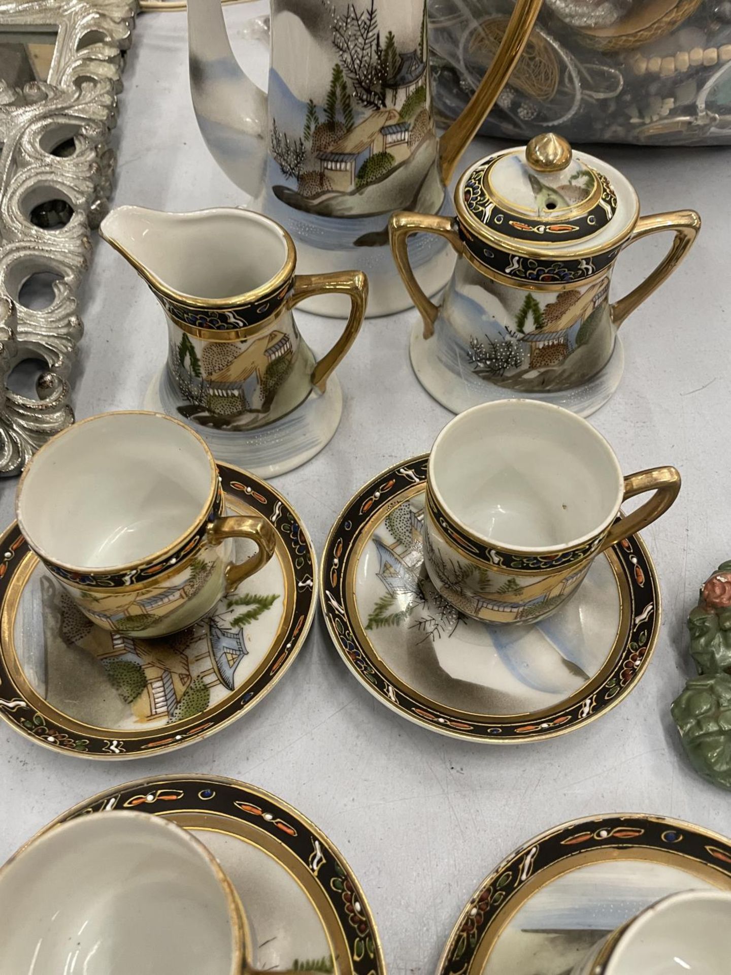 A JAPANESE COFFEE SET TO INCLUDE A COFFEE POT, A CREAM JUG, SUGAR BOWL, CUPS AND SAUCERS