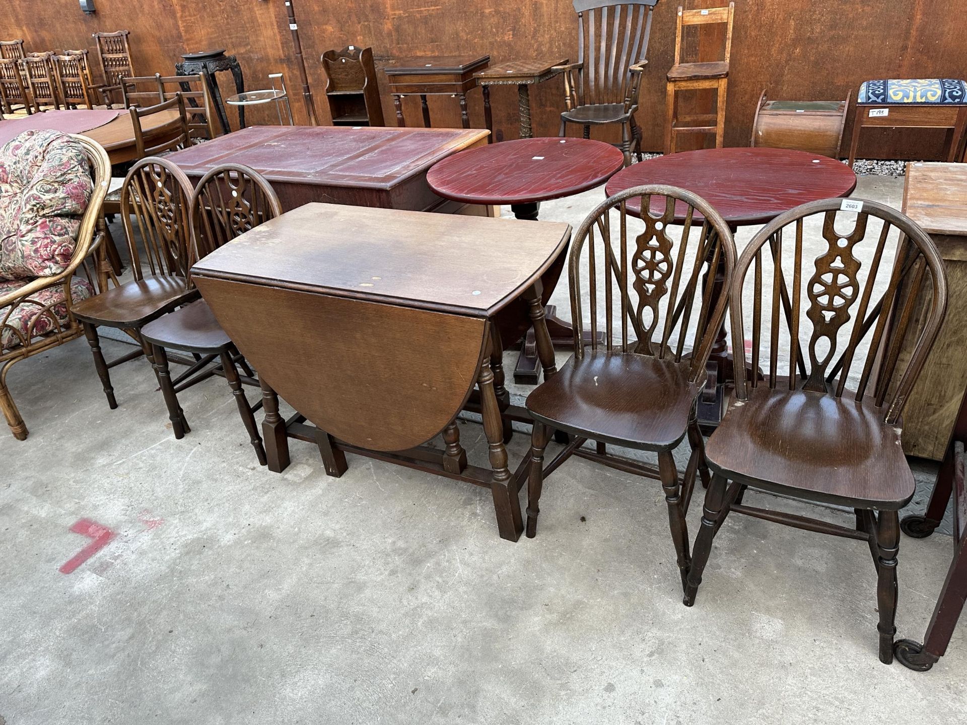 AN OVAL OAK GATELEG DINING TABLE 59" X38" OPENED AND FOUR WHEEL BACK WINDSOR STYLE CHAIRS