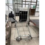 A METAL FOUR WHEELED MARKET GARDENERS TROLLEY IN WORKING ORDER BUT NO WARRANTY