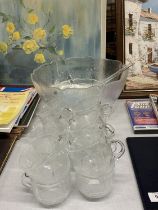 A GLASS PUNCHBOWL WITH CUPS