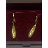A PAIR OF YELLOW METAL EARRINGS IN A PRESENTATION BOX