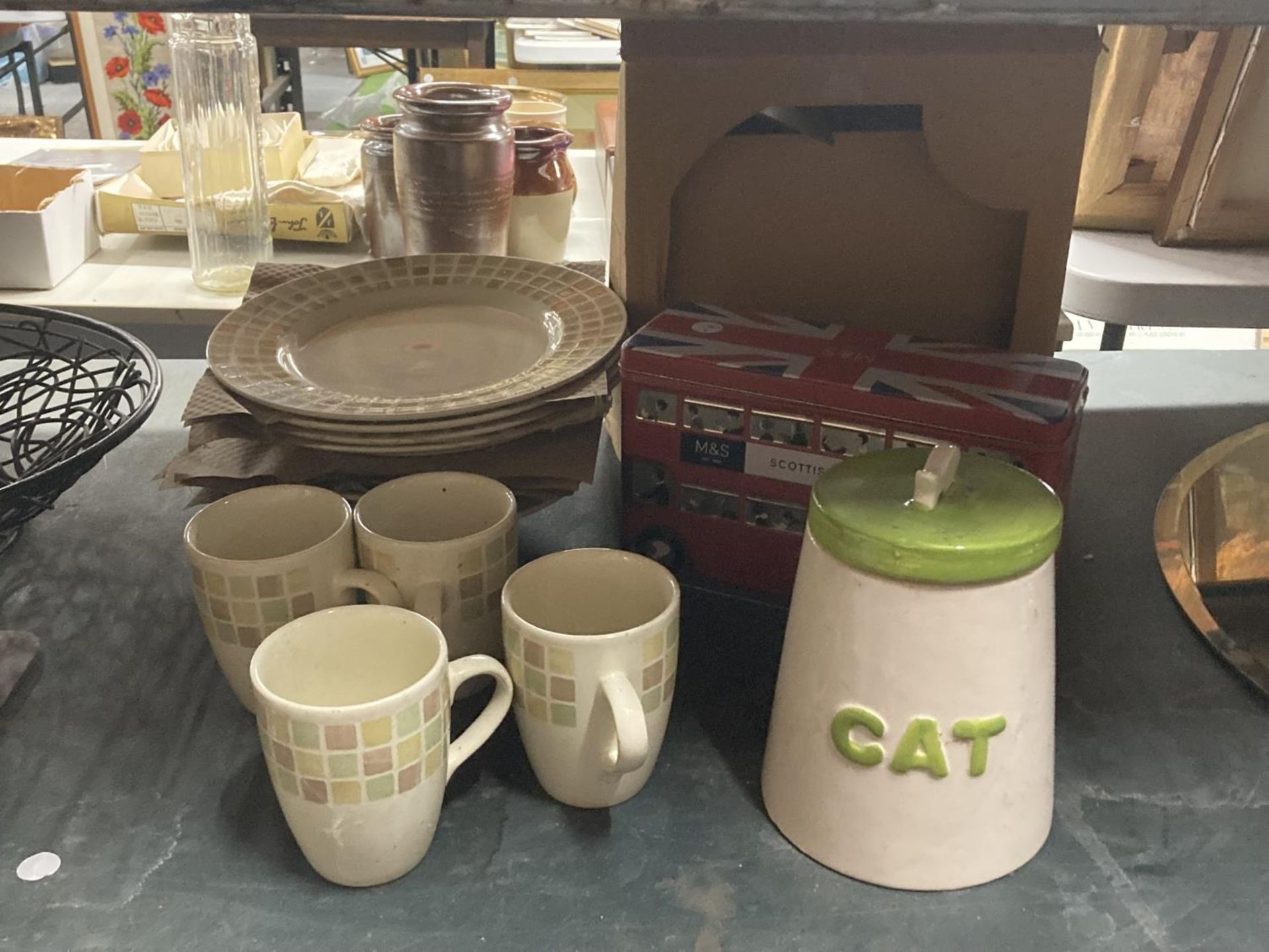 AN ASSORTMENT OF ITEMS TO INCLUDE MUGS WITH MATCHING PLATES, A BUS TIN ETC