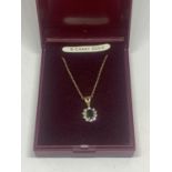 A 9 CARAT GOLD NECKLACE WITH A SAPPHIRE AND CUBIC ZIRCONIA PENDANT GROSS WEIGHT 1.54 GRAMS IN A