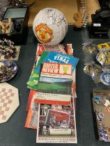 A COLLECTION OF VINTAGE MANCHESTER UNITED PROGRAMMES PLUS A SIGNED BALL