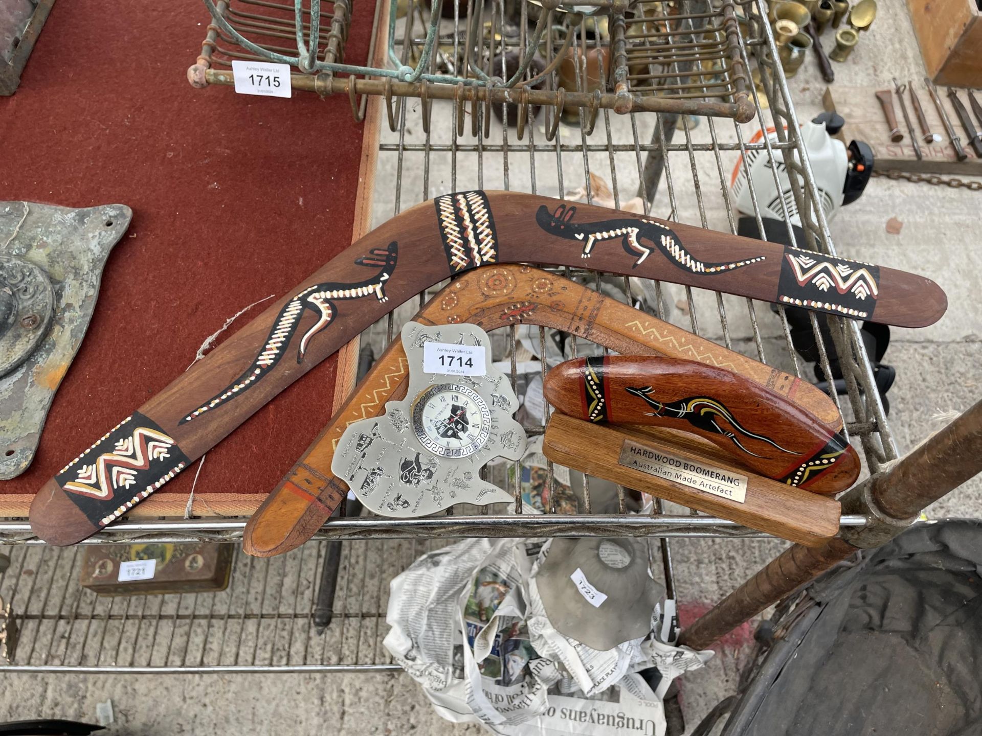 THREE WOODEN BOOMERANGS AND A CLOCK SET IN A MAP OF AUSTRALIA