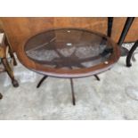 A RETRO CIRCULAR TEAK SPIDER LEG COFFEE TABLE WITH INSET GLASS TOP