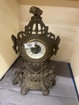 AN ORNATE VINTAGE BRASS STAND UP CLOCK, HEIGHT 36CM
