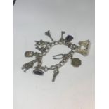 A SILVER CHARM BRACELET WITH TWELVE VARIOUS CHARMS