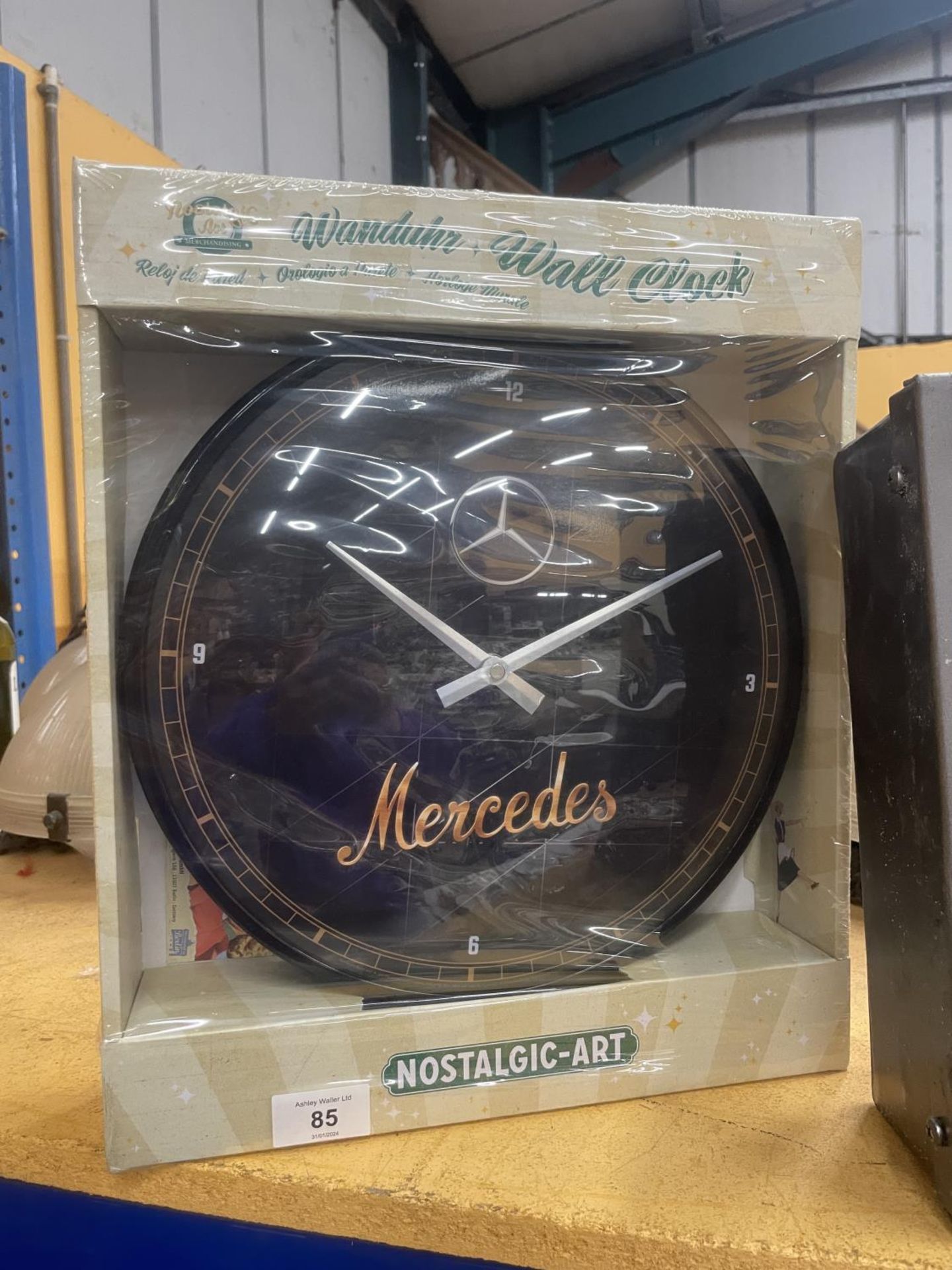 A NEW AND BOXED MERCEDES WALL CLOCK