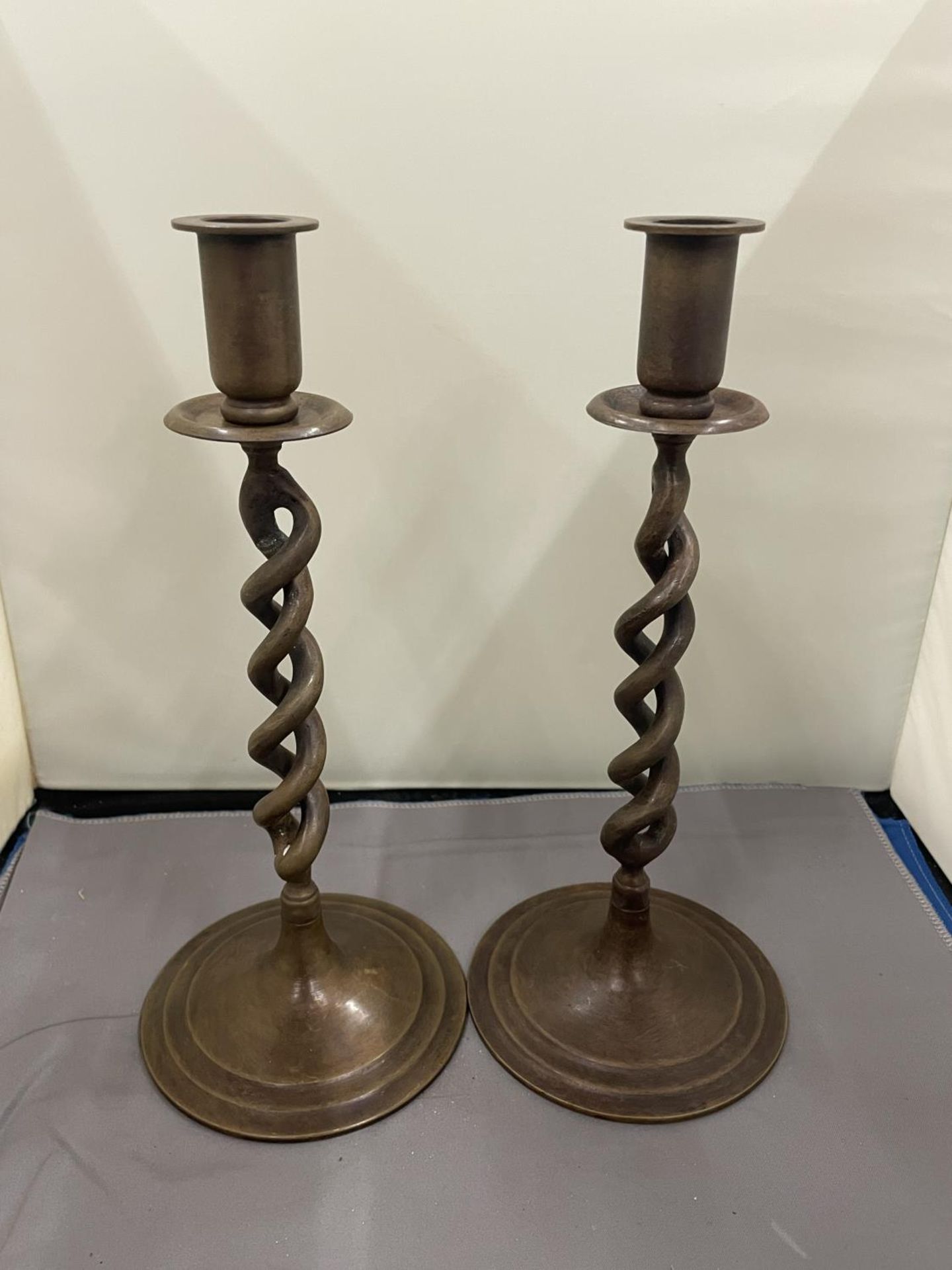 A PAIR OF TWISTED BRONZE CANDLESTICKS