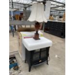 AN ELECTRIC FIRE IN THE FORM OF A LOG BURNER AND A WOODEN TABLE LAMP