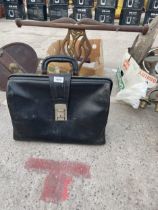 A VINTAGE LEATHER BRIEFCASE AND A TREEN CARVED FIGURE