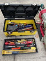 A STANLEY TOOL BOX WITH AN ASSORTMENT OF TOOLS TO INCLUDE AN AXE, SCREW DRIVERS AND PLIERS ETC