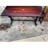 A COFFEE TABLE ON CAST IRON SCROLLED SUPPORTS, 36 X 16"