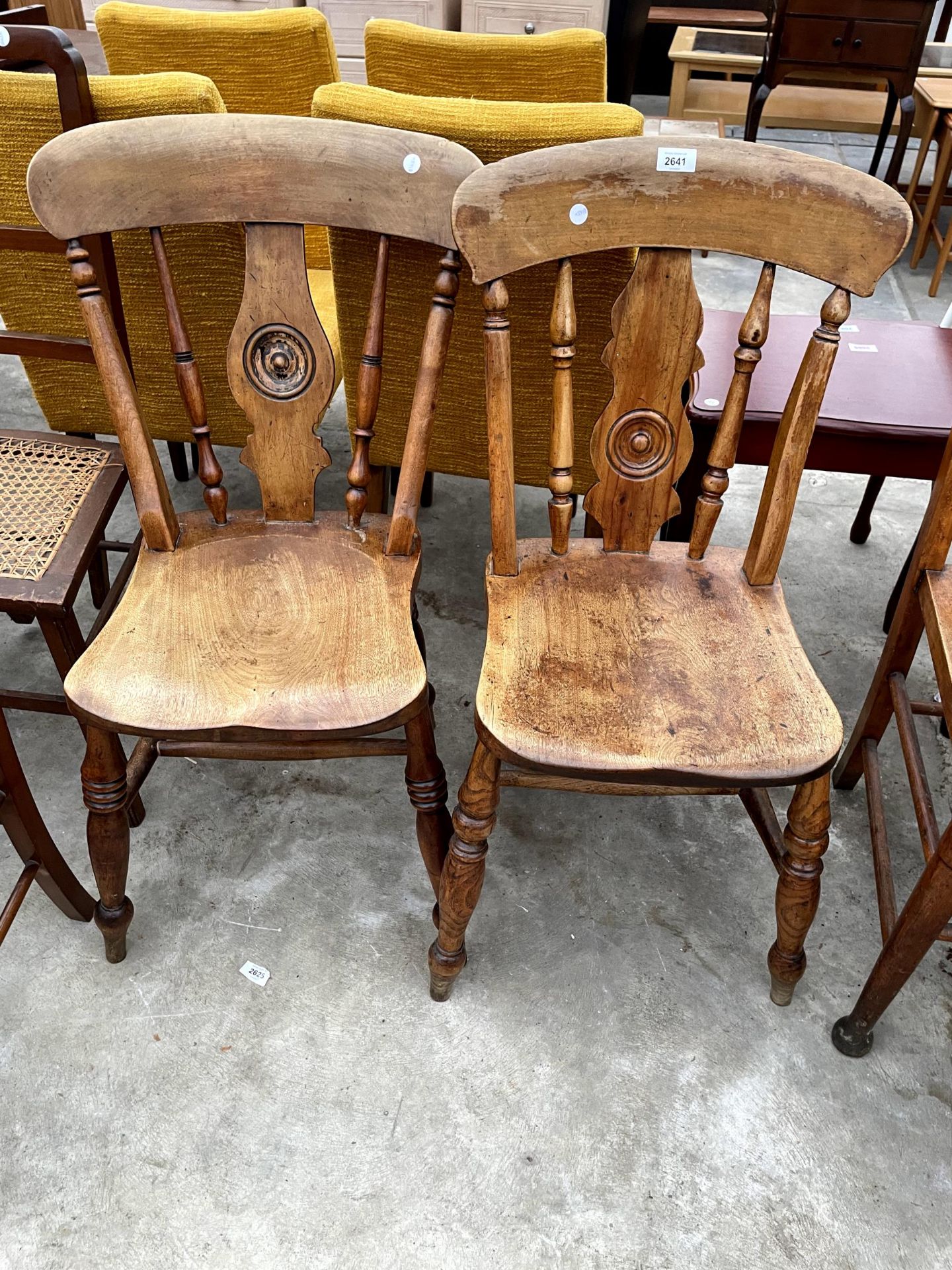 A PAIR OF VICTORIAN ELM AND BEECH KITCHEN CHAIRS WITH BULLSEYE BACKS