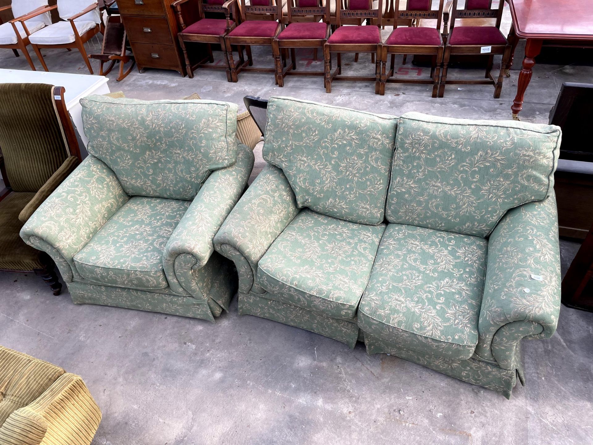 A MODERN GREEN FLORAL ADVANCE TWO SEATER SETTEE AND MATCHING EASY CHAIR