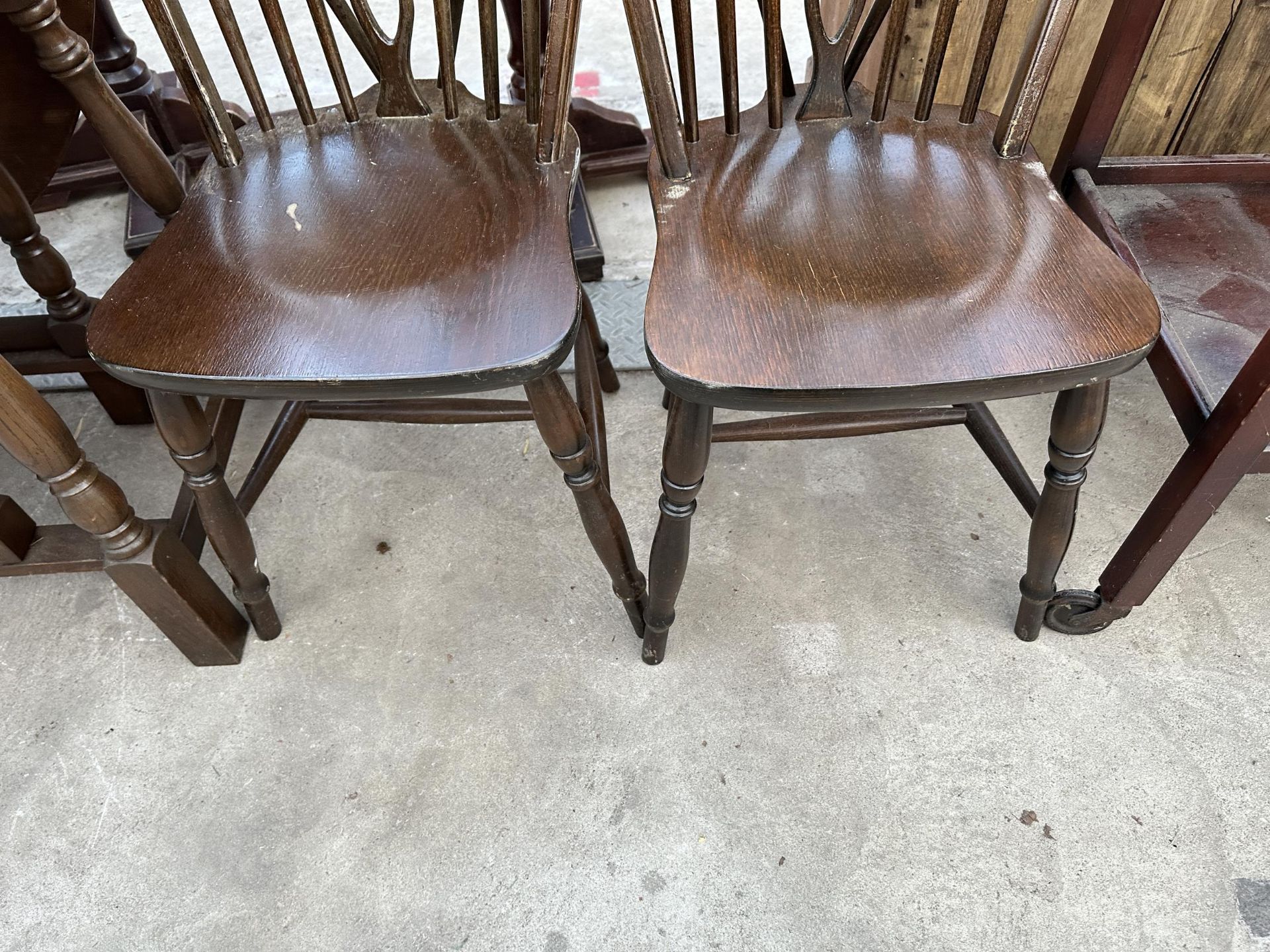 AN OVAL OAK GATELEG DINING TABLE 59" X38" OPENED AND FOUR WHEEL BACK WINDSOR STYLE CHAIRS - Image 3 of 7