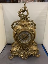 AN ORNATE GILT MANTLE CLOCK WITH ROMAN NUMERALS