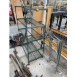 A GREENHOUSE SHELVING UNIT AND A METAL SAW HORSE