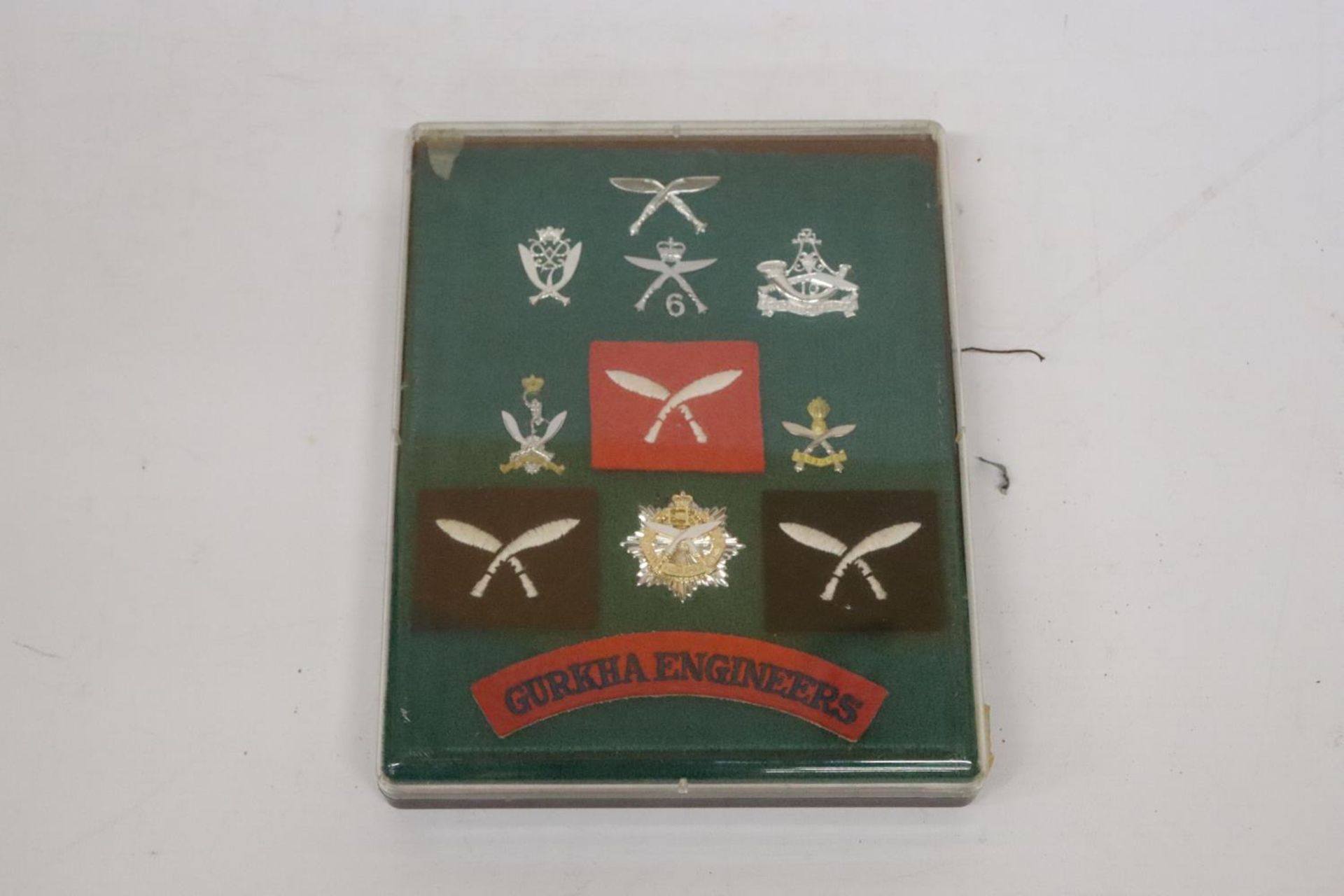 A CASED COLLECTION OF GURKHA BADGES