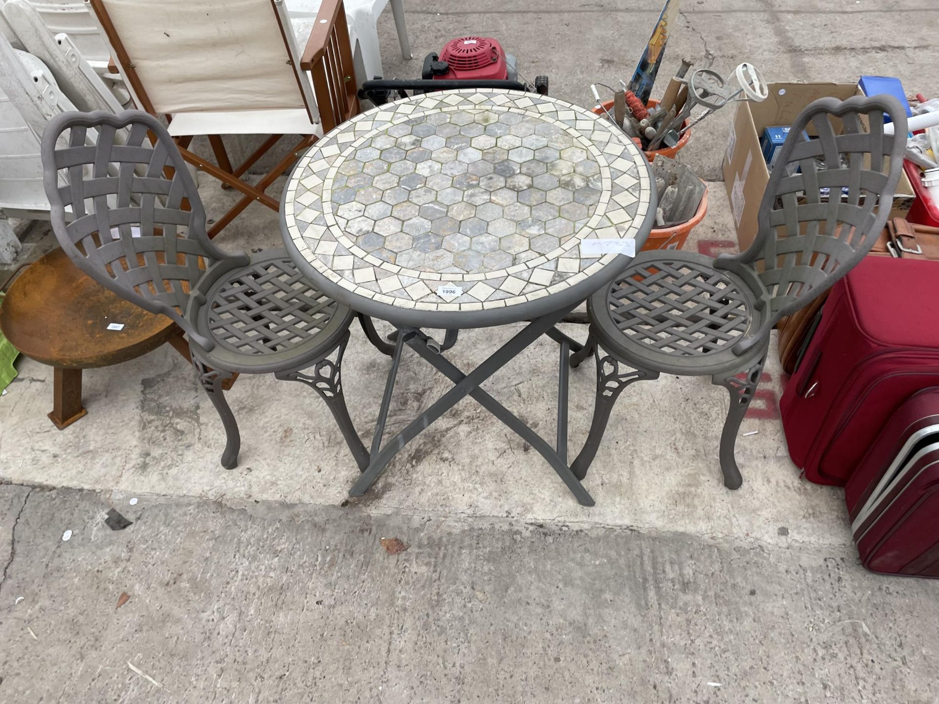 A METAL BISTRO SET COMPRISNG OF TWO CHAIRS AND A TILE TOP TABLE