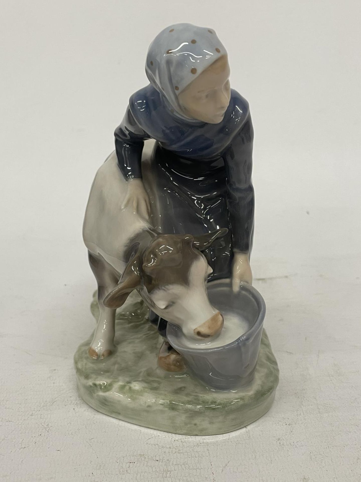 A ROYAL COPENHAGEN FIGURE OF A FARMGIRL AND CALF - DECORATION NUMBER 779 - DESIGNED BY CHRISTIAN - Image 2 of 5