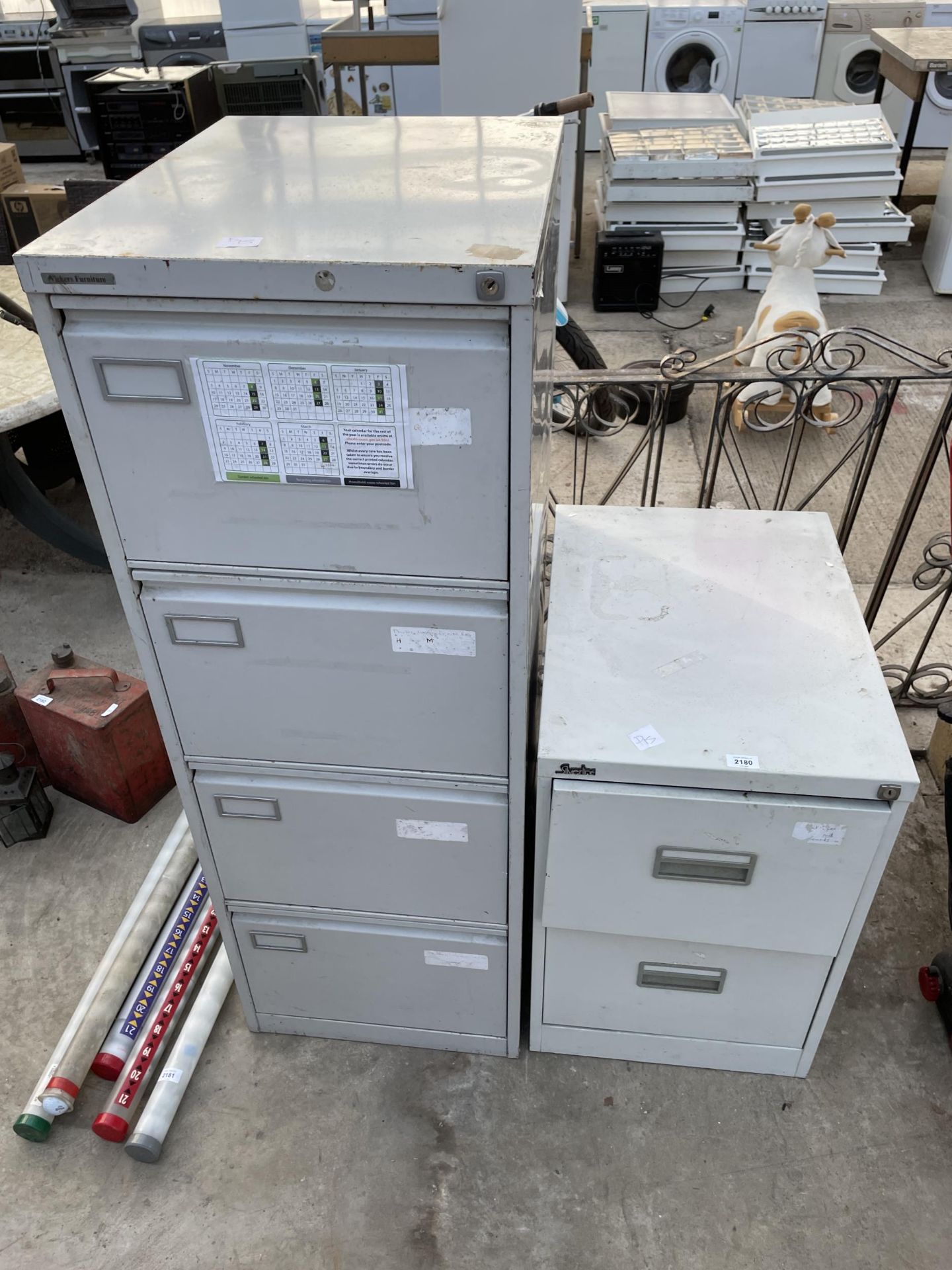 A FOUR DRAWER METAL FILING CABINET AND A FURTHER TWO DRAWER METAL FILING CABINET