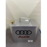 A SILVER AUDI OIL CAN