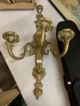 A BRASS WALL MOUNTED THREE BRANCH CANDELABRA