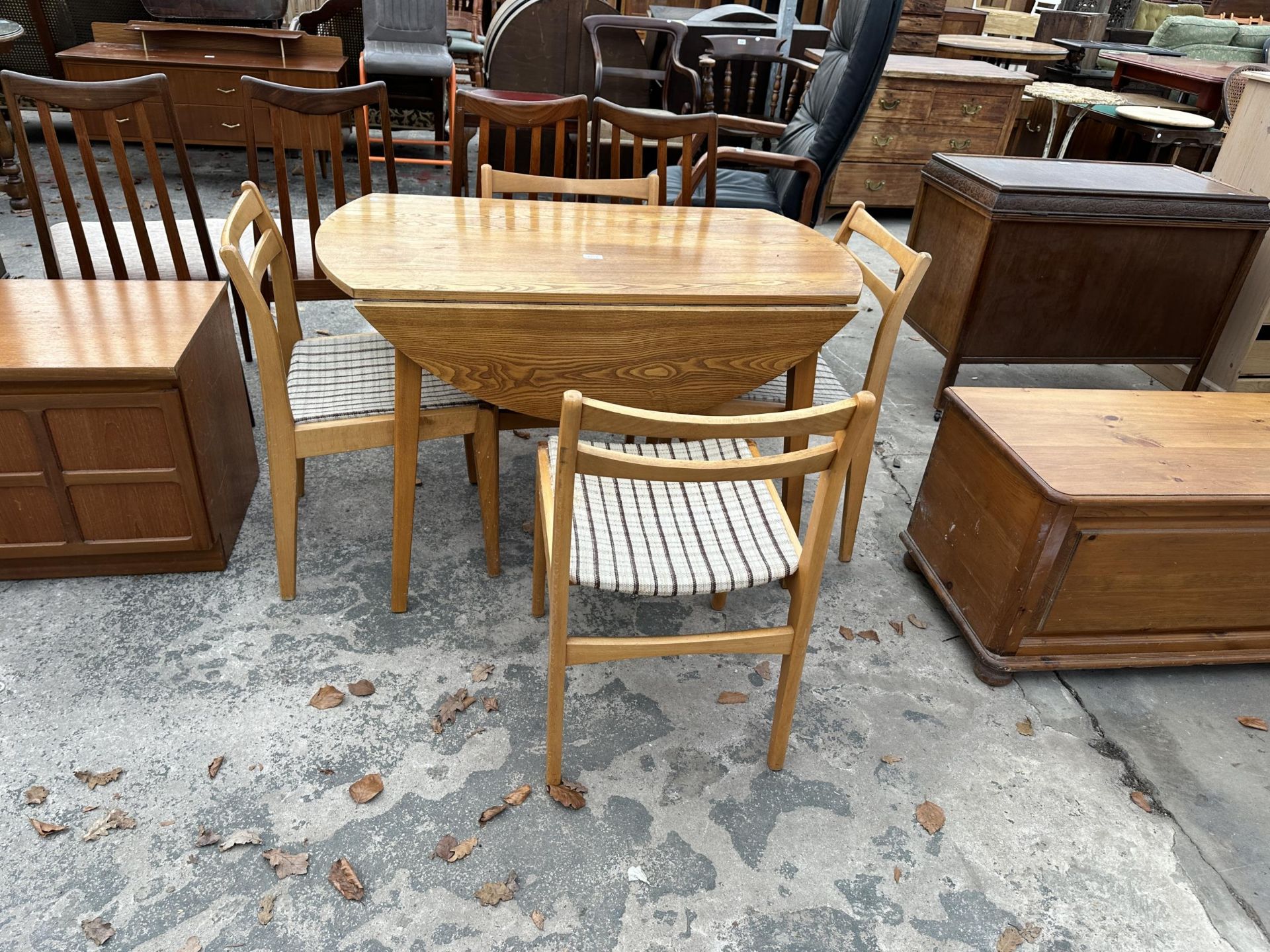 A DROP LEAF KITCHEN TABLE AND FOUR CHAIRS 44" DIAMETER