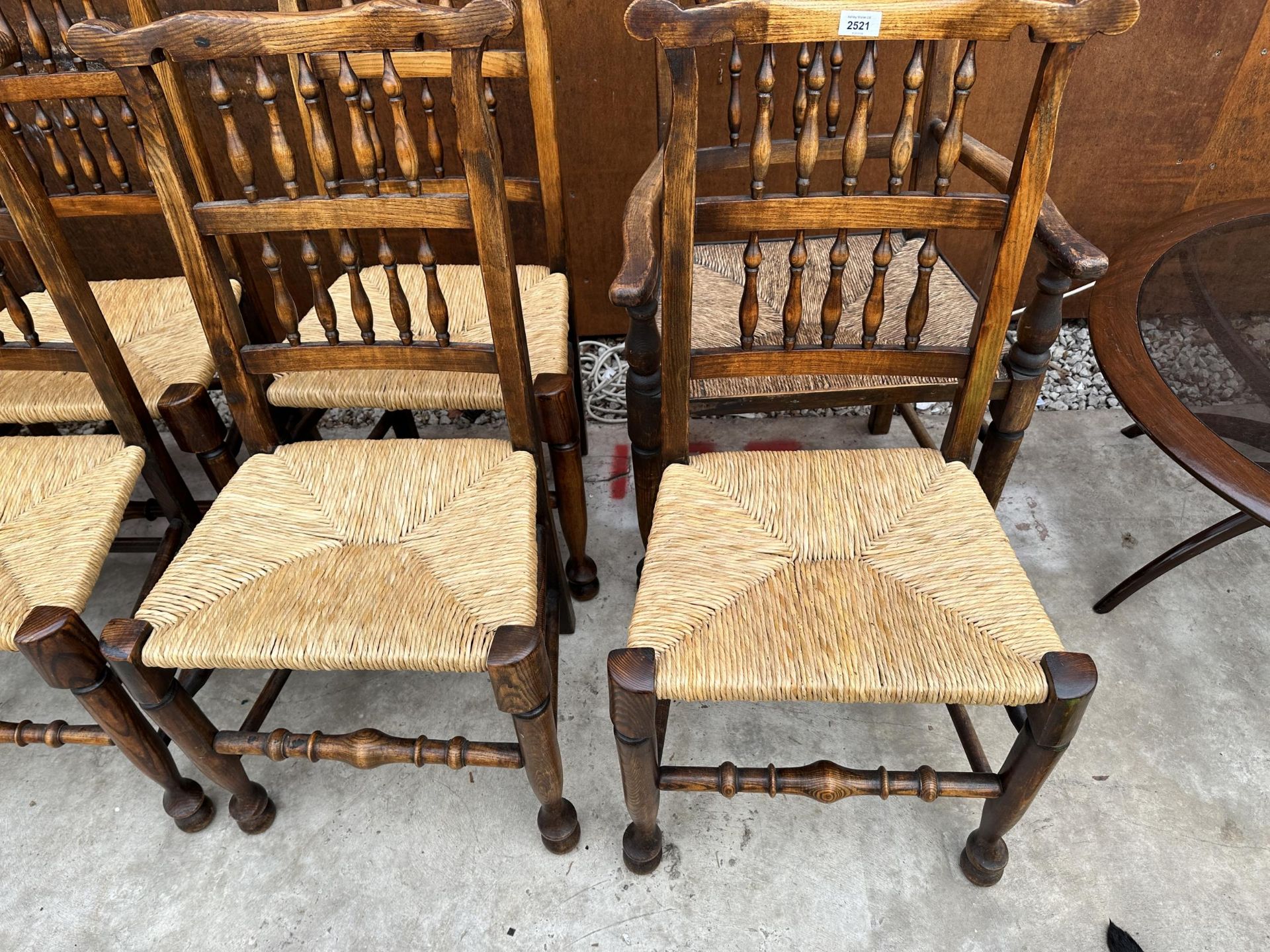 A SET OF EIGHT ELM AND BEECH LANCASHIRE SPINDLE BACK DINING CHAIRS, TWO BEING CARVERS, WITH RUSH - Image 2 of 5