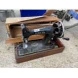 A VINTAGE SINGER SEWING MACHINE WITH A CARRY CASE